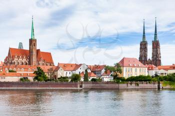 travel to Poland - view of Ostrow Tumski district in Wroclaw city with Collegiate Church of the Holy Cross and St Bartholomew, Cathedral of St John the Baptist, Archbishop's, palace from Oder River