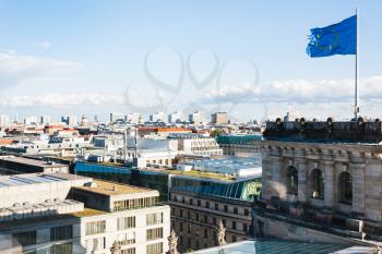 travel to Germany - above view of Berlin city and EU flag over Reichstag in september