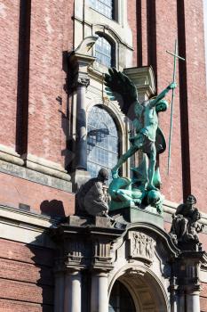 Travel to Germany - Victory of St Michael over the Devil, sculpture above the entrance of St Michael's church (Hauptkirche Sankt Michaelis) in Hamburg city
