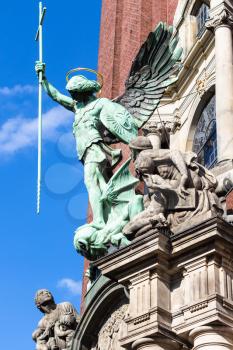 Travel to Germany - Victory of St Michael over the Devil, statue above the entrance of St Michael's church (Hauptkirche Sankt Michaelis) in Hamburg city