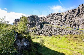 travel to Iceland - tourists on road in Almannagja gorge in Thingvellir national park in september