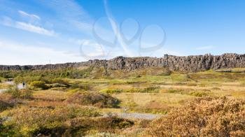 travel to Iceland - path to rocks in rift valley in Thingvellir national park in september