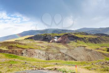 travel to Iceland - rainbow in mountains in Hveragerdi Hot Spring River Trail area in september
