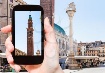 travel concept - tourist photographs Piazza dei Signori near Basilica Palladiana in Vicenza city in Italy on smartphone