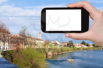 travel concept - tourist photographs Verona city with waterfront of Adige river in Italy in spring on smartphone with cut out screen for advertising logo