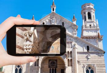 travel concept - tourist photographs Duomo Cathedral in Verona city (Cattedrale Santa Maria Matricolar, Duomo di Verona) in Italy on smartphone