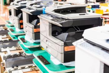 several new assembled copiers in line in factory