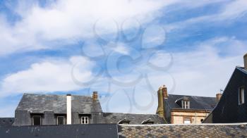 travel to France - blue sky with white clouds over houses in Etretat town in Normandy