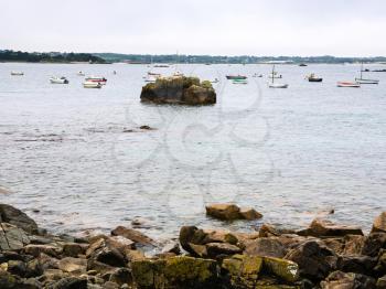 travel in France - boats near beach of Gouffre gulf of English Channel near Plougrescant town of the Cotes-d'Armor department in Brittany in summer