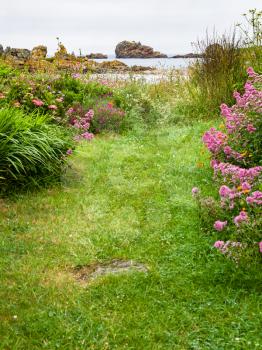 travel in France - green meadow on coast of Gouffre gulf of English Channel near Plougrescant town of the Cotes-d'Armor department in Brittany in summer