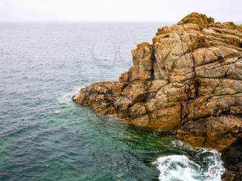 travel in France - view of cliff in Gouffre gulf of English Channel near Plougrescant town of the Cotes-d'Armor department in Brittany in summer rainy day