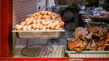 travel to France - local fresh seafood ( langoustines and crabs) in outdoor window of fish shop in Treguier town in the Cotes-d'Armor department of Brittany in summer