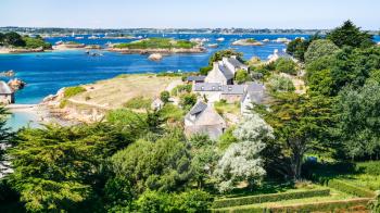 travel to France - above view of country houses on ocean coast in Brehat commune at Ile-de-Brehat island in Cotes-d'Armor department of Brittany in summer sunny day