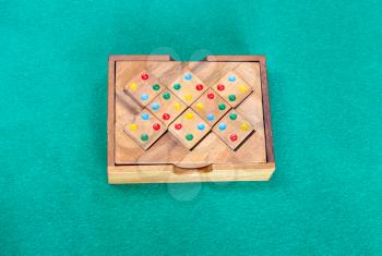 wooden box with puzzle on green baize table