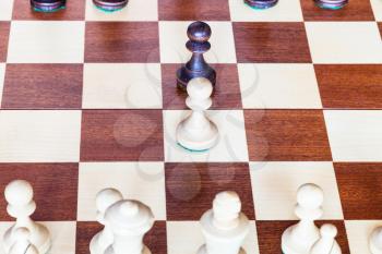 view from white side of first chess pawn moves on chessboard