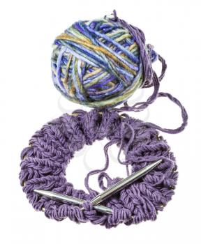 above view of knitted snood scarf with knitting needles and ball of multicolor yarn isolated on white background