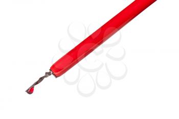 side view of ink drop on tip of red nib pen close up isolated on white background