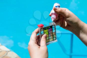 Addition of a chemical to pH meter for measure the acidity of water in a swimming pool