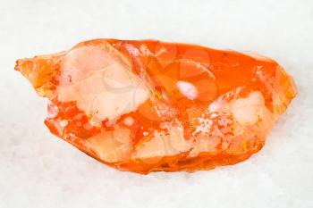 macro shooting of natural mineral - raw noble opal and fire opal gem stone on white marble from Ural Mountains