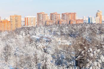 above view of snow-covered Timiryazevsky park and Bolshaya Akademicheskaya street with modern residential buildings in Moscow city in sunny winter day