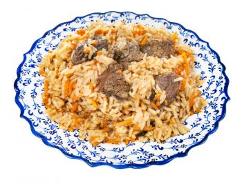 above view of cooked pilaf (central asian dish from rice with meat and vegetable) on local ceramic plate isolated on white background