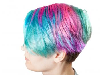 above view of female head with multi colored dyed hairs on white background