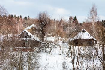 old rural houses in little russian village in winter in Smolensk region of Russia