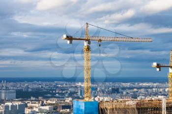 crane at construction site of skyscraper in Moscow city in autumn day