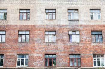 facade of shabby wall of old multistorey brick house in Moscow city