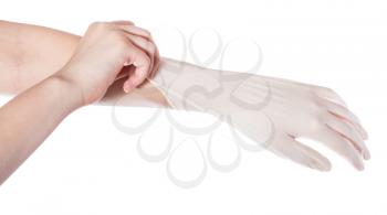 above view of female hand pulls latex glove on another hand isolated on white background