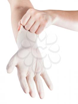 front view of female hand wears latex glove on another hand isolated on white background