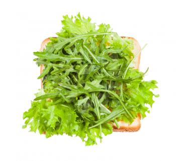 top view of open sandwich with toast and fresh greens isolated on white background