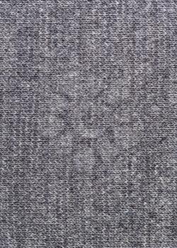 textile vertical background - woven texture of gray wool jersey knitted fabric close up