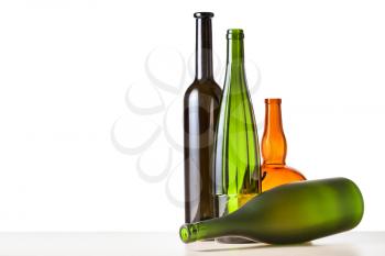 several empty bottles on wooden board with cutout background