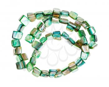 top view of tangled string of beads from green colored pieces of abalone shells isolated on white background