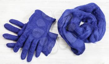 workshop of hand making a fleece gloves from blue Merino sheep wool using wet felting process - woolen felted gloves and fur material for them