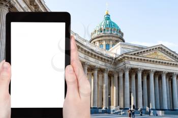 travel concept - tourist photographs of Kazan Cathedral in Saint Petersburg city in March on smartphone with empty cutout screen with blank place for advertising