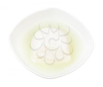 portion of fresh mozzarella italian cheese with brine in bowl isolated on white background