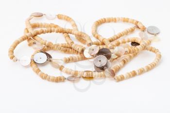 tangled African necklace from natural bone beads on white paper background