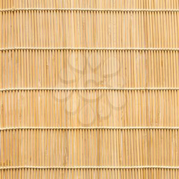 square background of wooden mat woven from linden wood sticks
