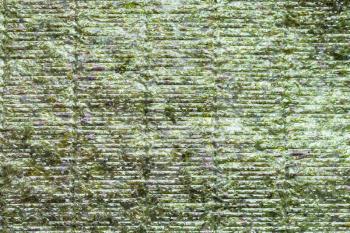 food background - textured dried sheet Nori of seaweed used in Japanese cuisine for sushi