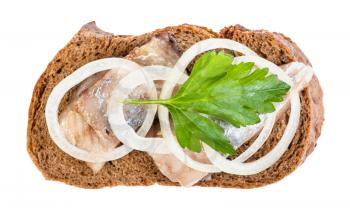top view of open sandwich with rye bread and pickled herring decorated of onion rings and fresh green parsley leaf isolated on white background