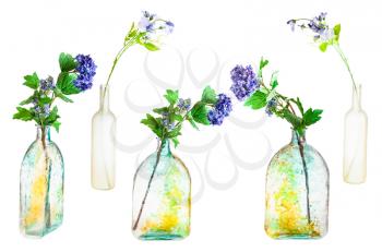set of artificial flowers in hand painted glass bottles isolated on white background