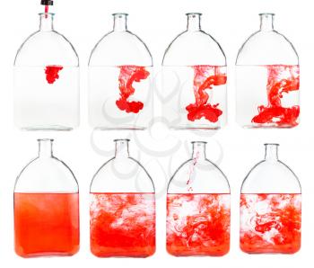 set of red ink solutions in water in glass flask isolated on white background