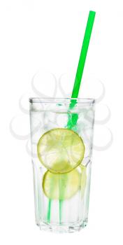 side view of gin and tonic cocktail in highball glass with two slices of lime, ice and green plastic straw isolated on white background