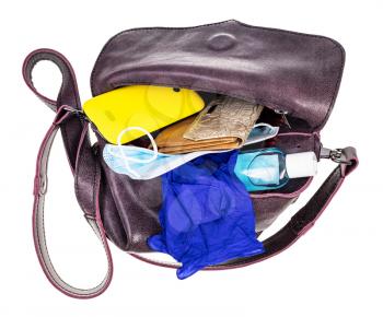 top view of ladies bag with protective items, wallet and smartphone isolated on white background