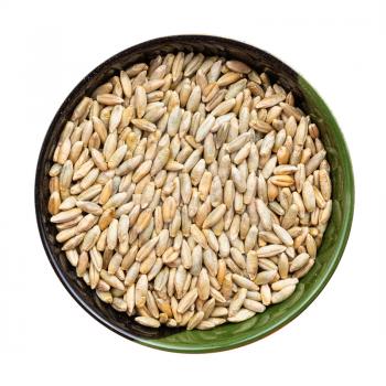 top view of whole rye grains in round bowl isolated on white background