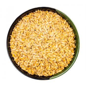 top view of golden flax seeds in round bowl isolated on white background