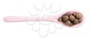 top view of ceramic spoon with allspice jamaica peppers isolated on white background