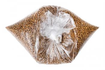 raw roasted buckwheat grains in knotted plastic bag isolated on white background